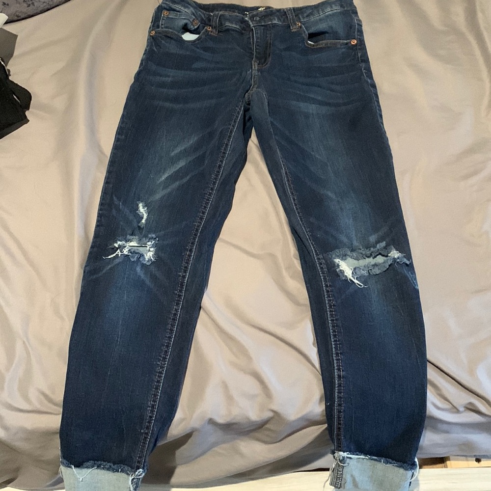 Dark wash skinny jeans with rips in the knees